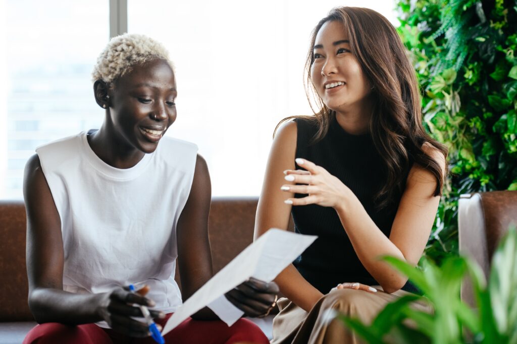 two female friends laughing at work