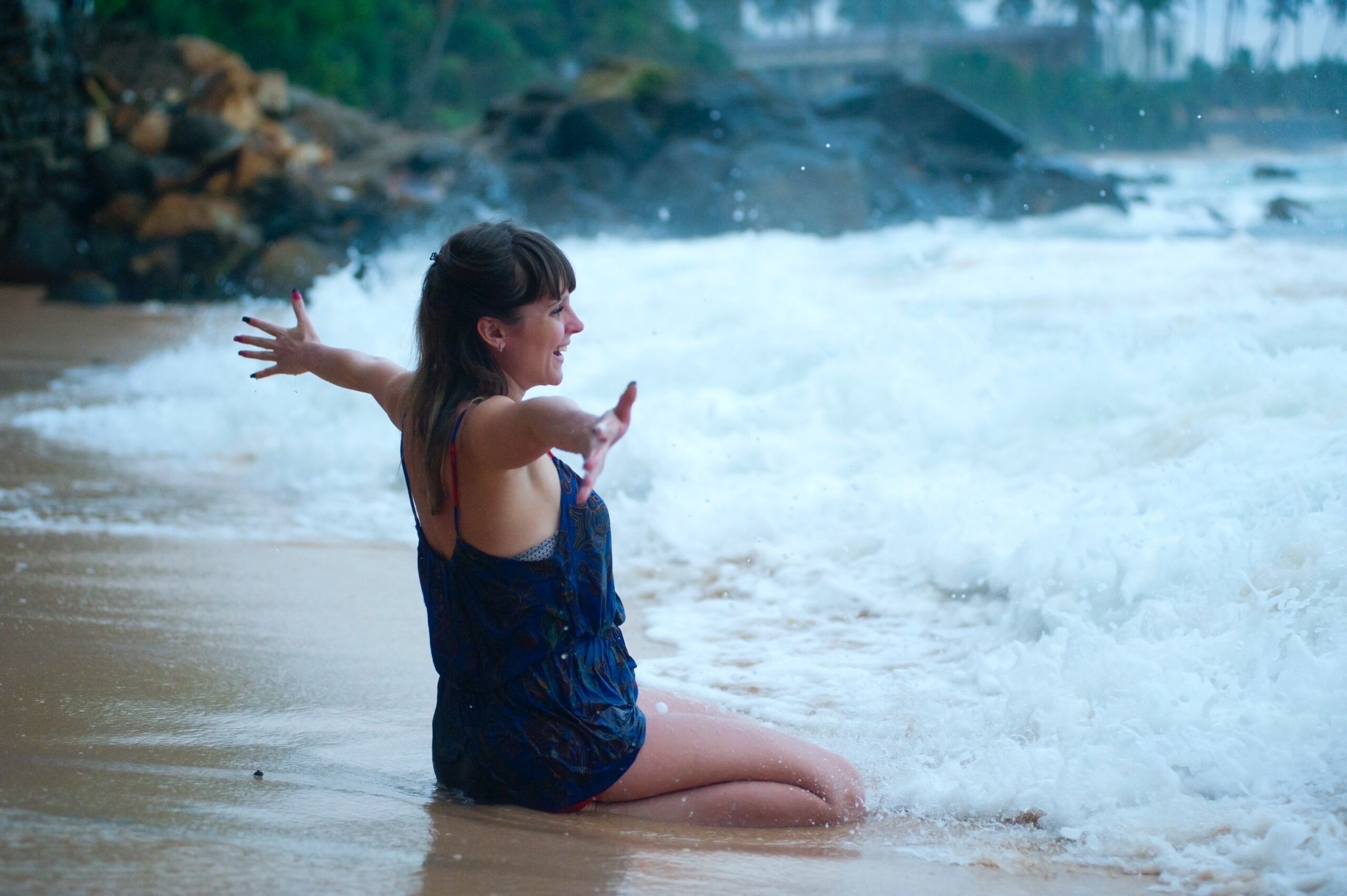 A lady embracing the ocean at the shore