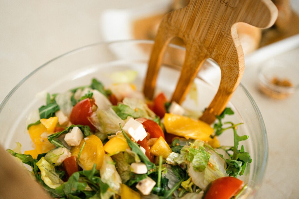 A mixed green salad with a salad fork 