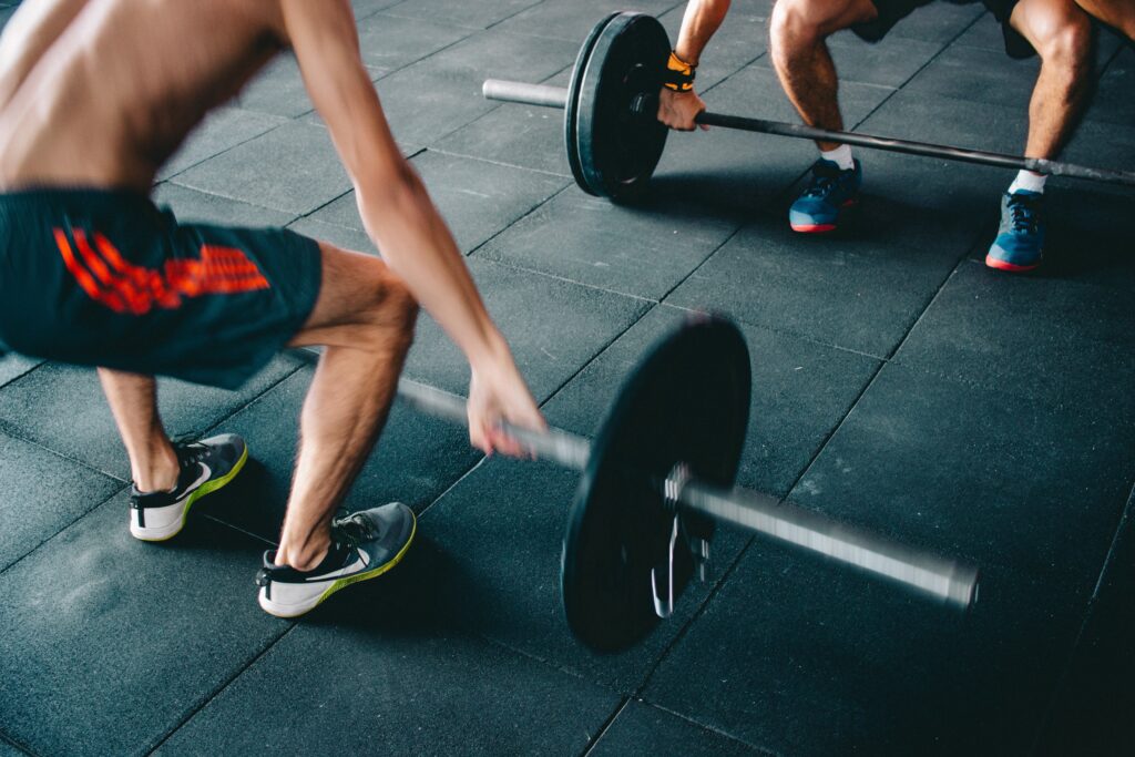 Someone deadlifting a barbell at the gym 